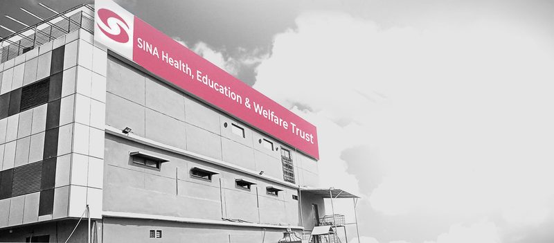 A SINA clinic building in Karachi with its red sign
